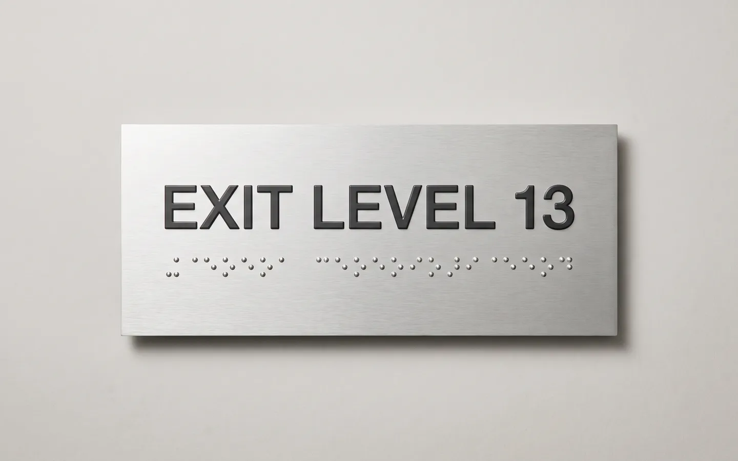 Braille sign customiser preview showing printed wording with a generated braille dot row on a plate