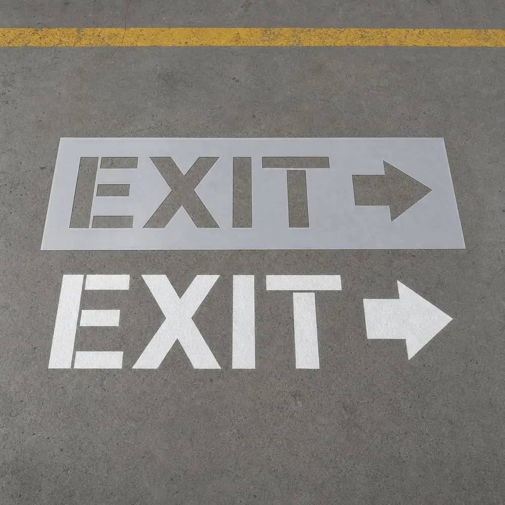 Reusable Mylar EXIT stencil beside a finished warehouse floor marking