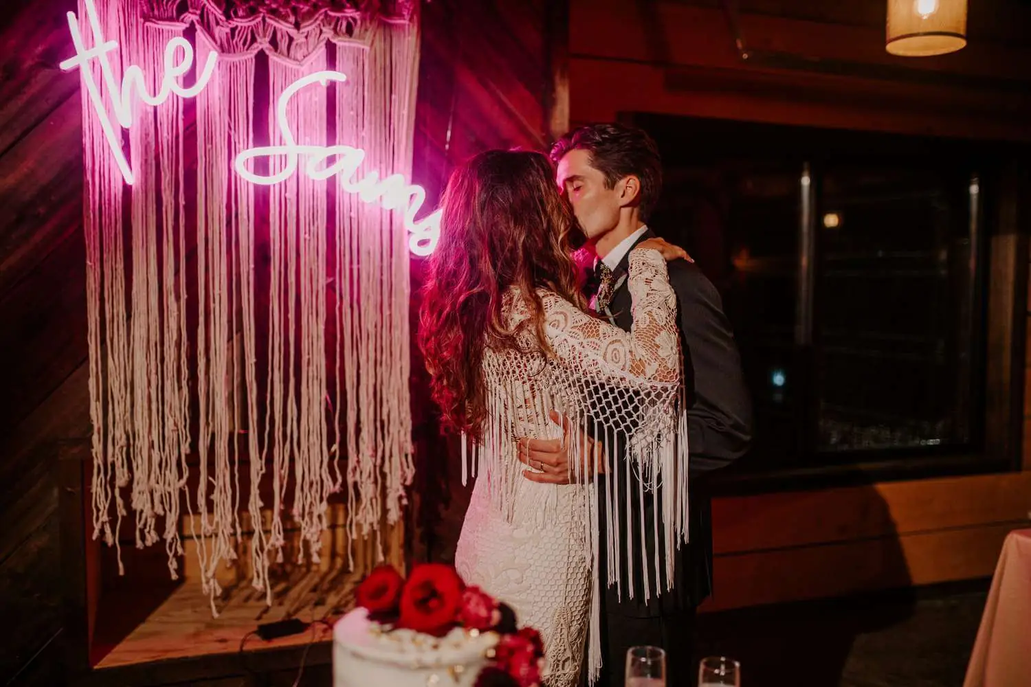 A custom neon sign used as a photo backdrop at a wedding reception