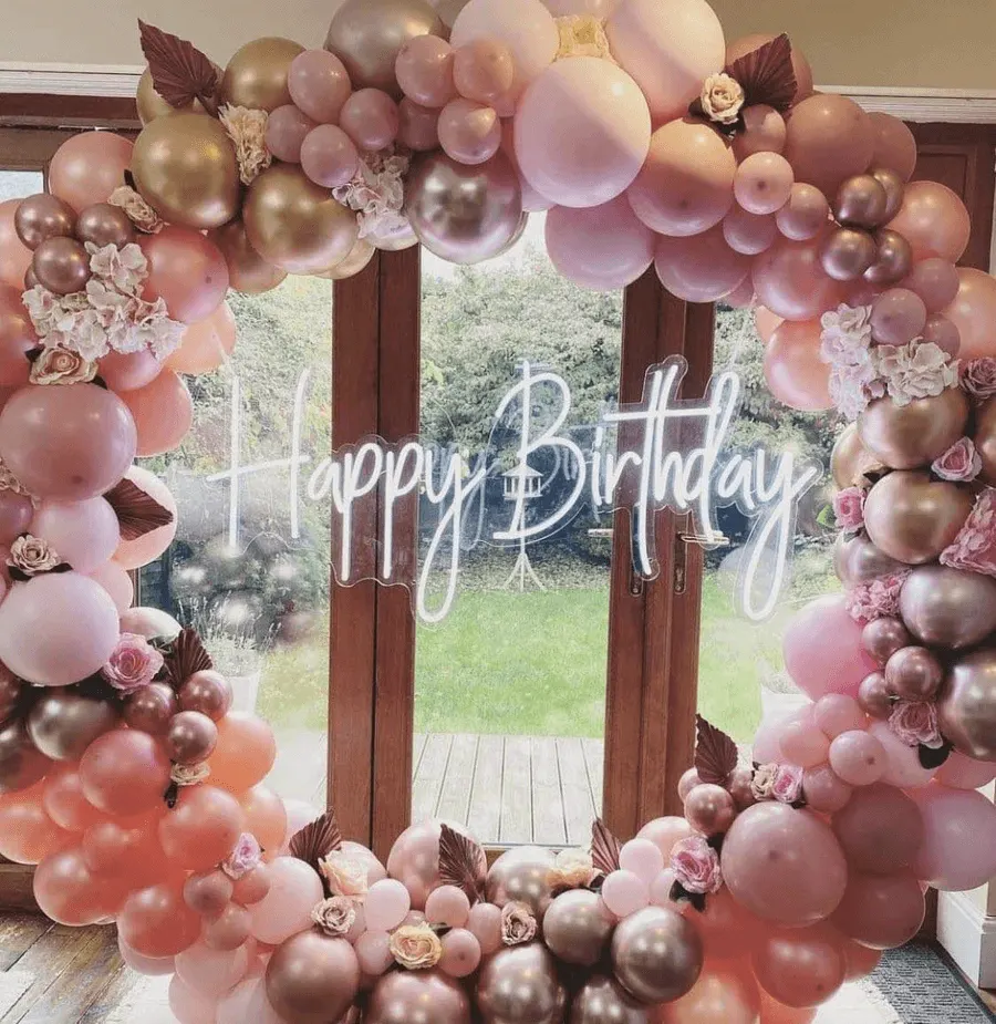 A bright multi-colour neon sign used as party decor