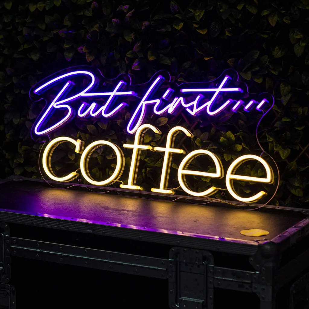 A restaurant interior using a custom neon sign with the venue's name as a feature wall